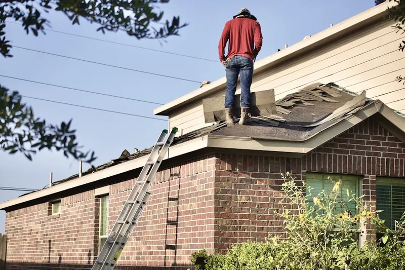 Professional roofer working on a residential roof in Encina